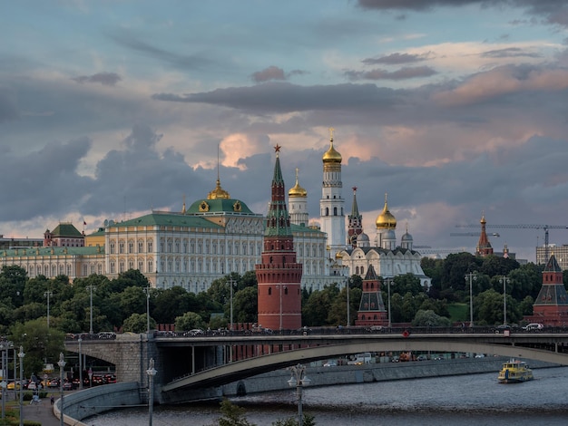 spasskaya tower by moscva river against cloudy sky