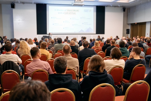 Photo speaker at business conference and presentation audience at the conference hall