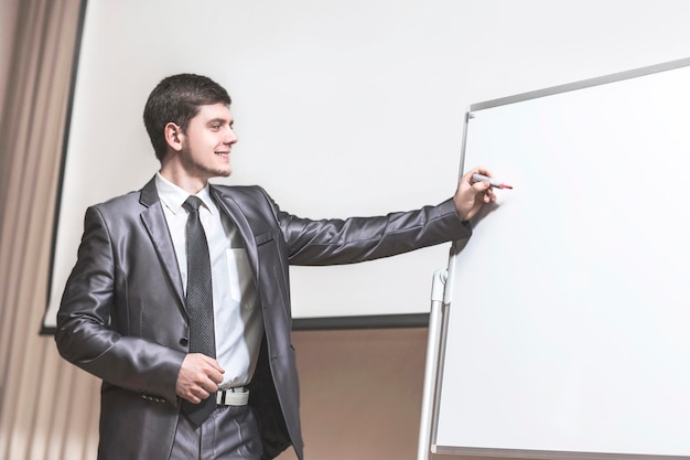 Speaker at business conferences standing in front of the board for business presentations