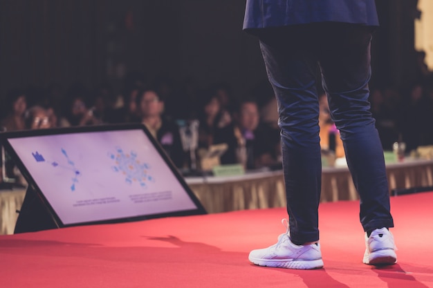 Speaker on stage in a conference room