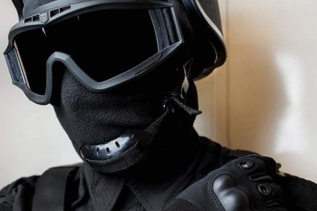 Special forces in black uniform mask and body armor swat safety\
goggles for tactical helmet