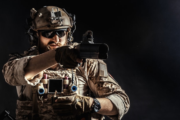 Special forces soldaat met geweer op donker