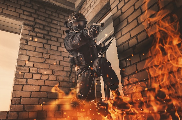 Special forces soldier frees hostages from a building on fire.
swat