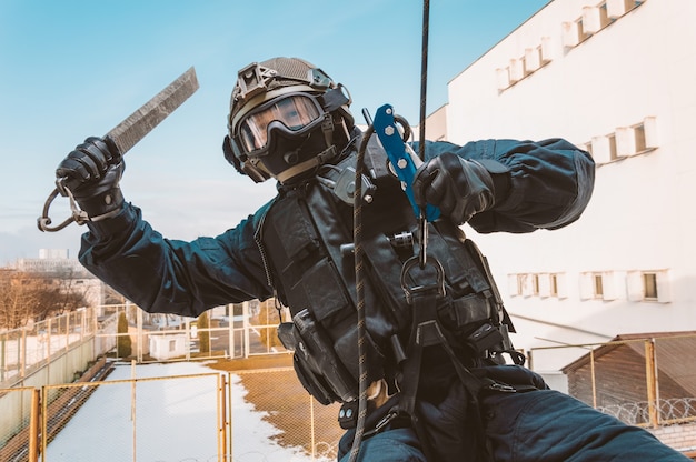 Special forces soldier storms the building through the window