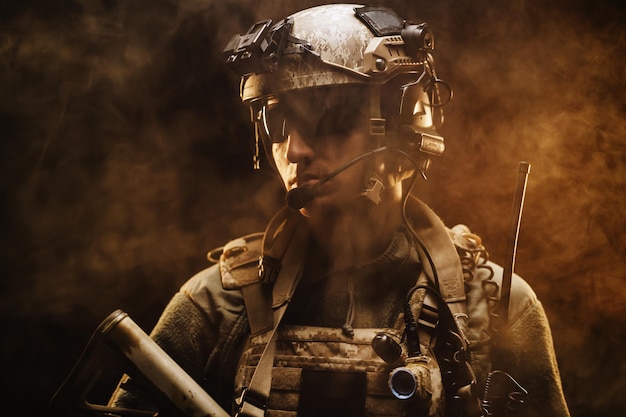 Special forces soldier with rifle on black background