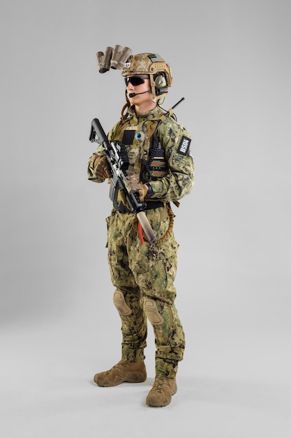 Special forces soldier with rifle on white.