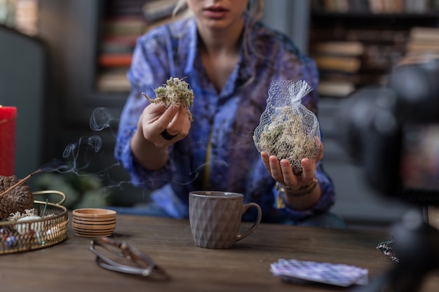 Photo special herbs. selective focus of a bag with herbs being held by a witch during the ritual