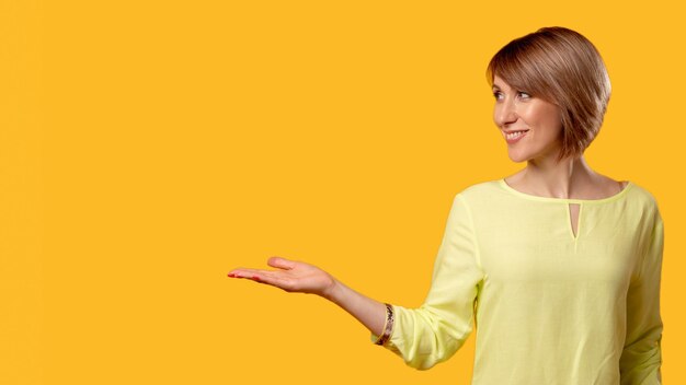 Special offer solution way advertising background cheerful mature woman in yellow blouse recommendin