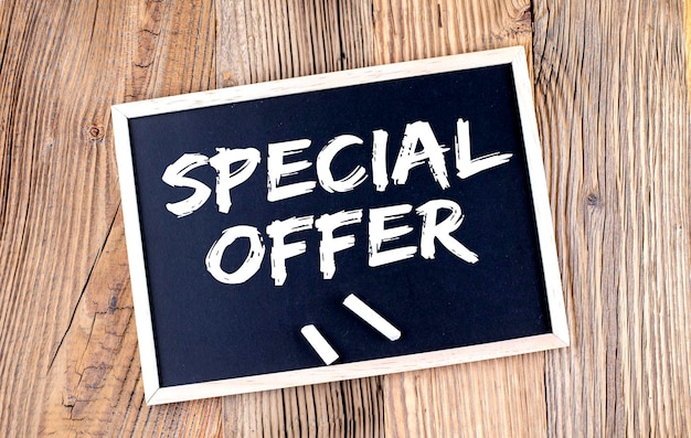SPECIAL OFFER text on a chalkboard on the wooden background