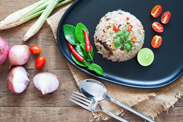 Special Thai dish. Fried rice with mackerel, chilli, lime leaves, onion and Thai herbs. Top view