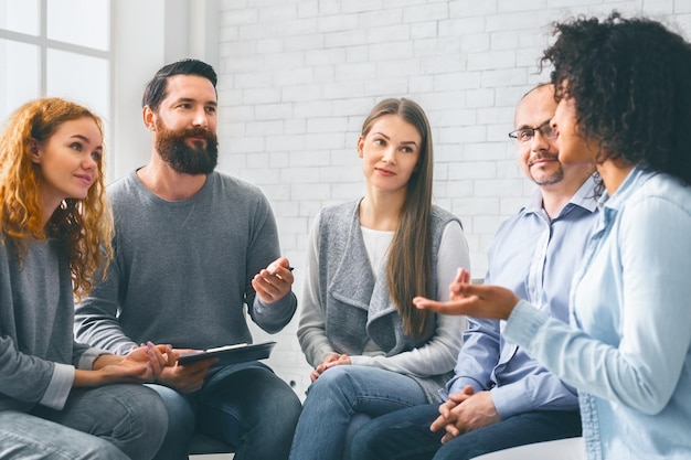 Specialist giving advices to patients during group therapy