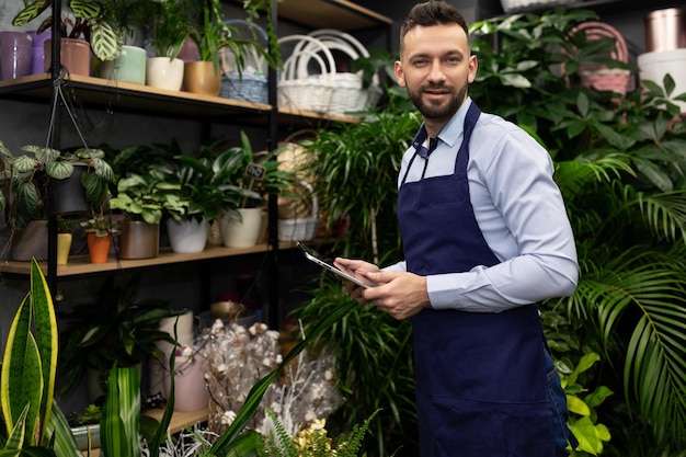 Specialist in the sale of flowers in a shop of garden plants and bouquets