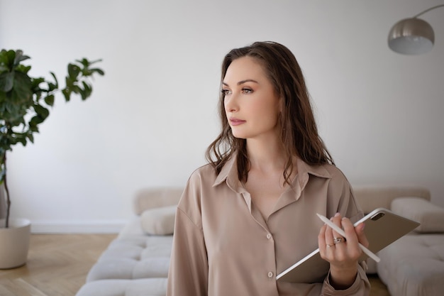 A specialist woman with a tablet in her hands gives consultations a conversation in a pleasant inter