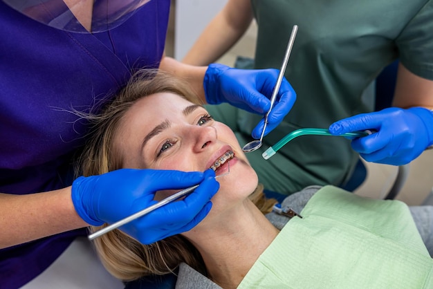 In a specialized dental clinic a female dentist receives clients with problem teeth