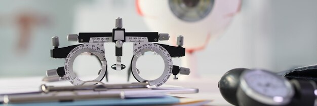 写真 ぼやけた現実的な目のモデルのプロに対するテーブル上の視力検査に使用される眼鏡