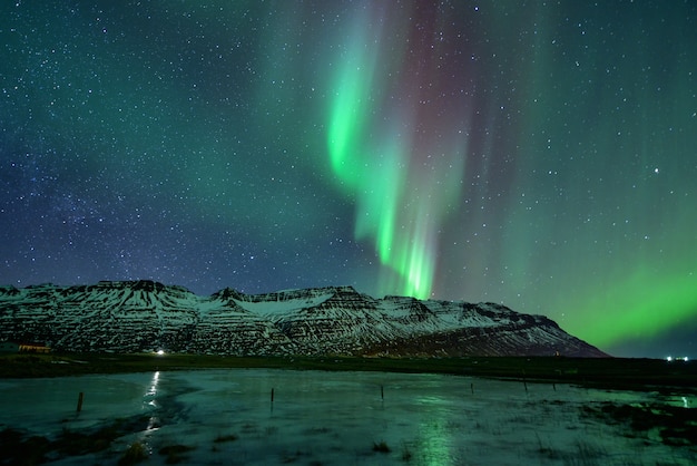 Spectacular auroral display at night over mountian, Iceland