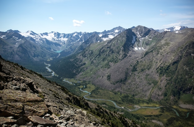 Spectacular mountain scenery. River with blue water flows in a valley between two mountains.