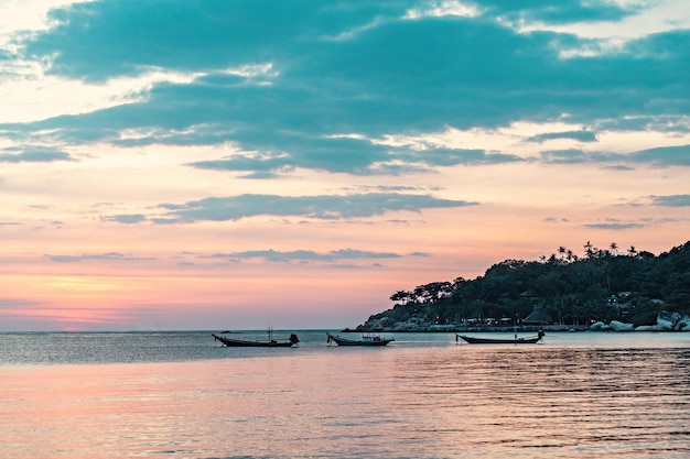 Spectacular sunset with boats on the beach, Koh Tao, Thailand