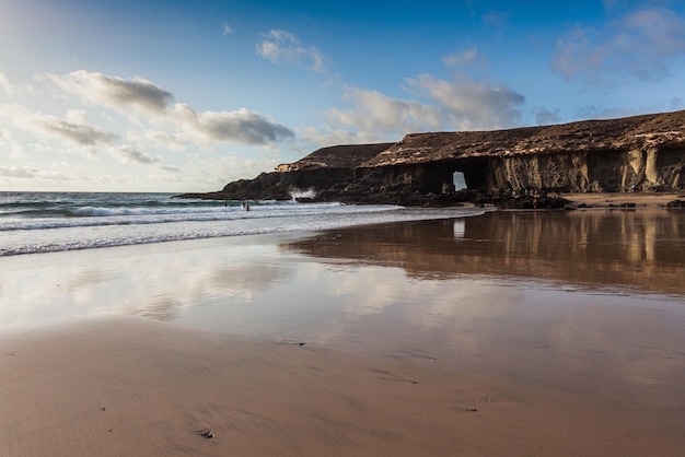 Spectacular sunset with reflections in the sands at Playa de Garcey, on the south west coast of Fuer