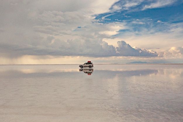 Spectacular view of Uyuni Salt Lake, Bolivia. Offroad car in Salar de Uyuni salt lake, Bolivia