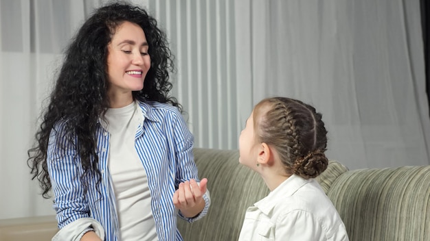 Speech therapist helps girl kid make correct sound at home