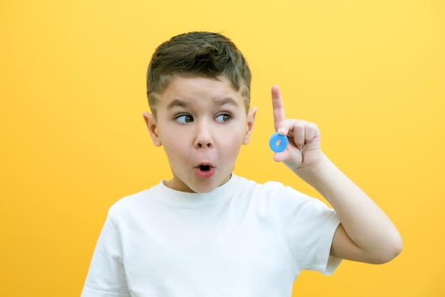 Speech therapy Toddler boy says the letter O Classes with a speech therapist boy on isolated yellow background