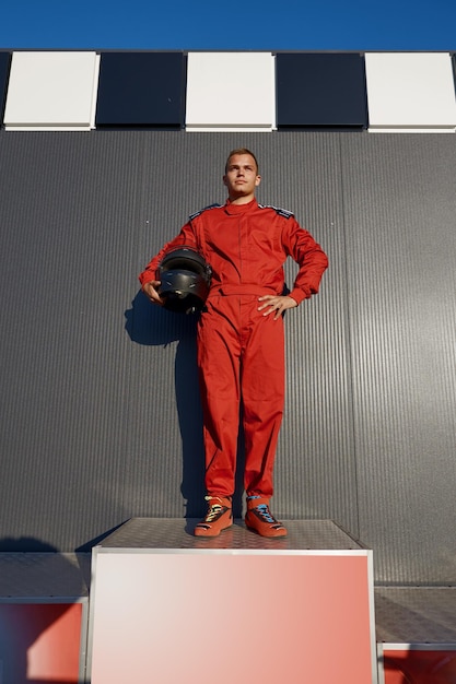 Speed gocart driver winner standing on pedestal achieving first place