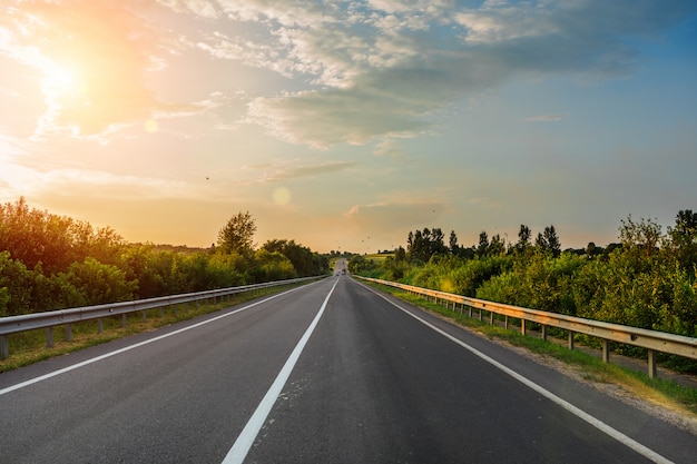 Speed highway through the field. asphalt-paved roada