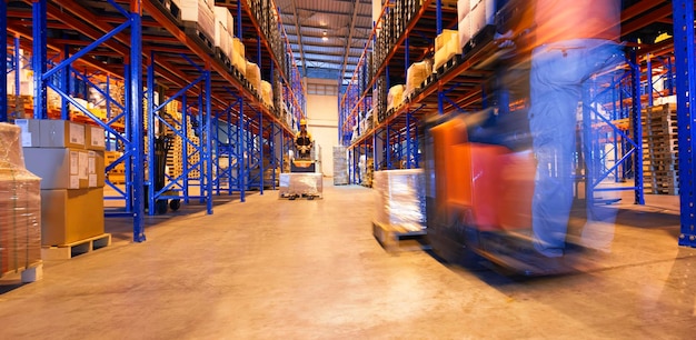 Photo speed motion of workers unloading package boxes in warehouse electric forklift pallet jack