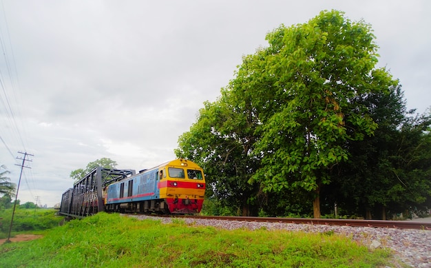 Speed train transporting through the black iron railway bridge at Chiang-mai Thailand