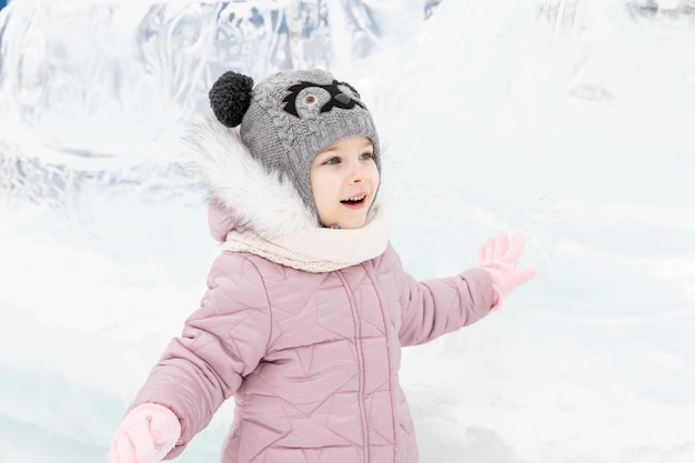 Foto speels kindmeisje gelukkig in sneeuwstad op winterdag