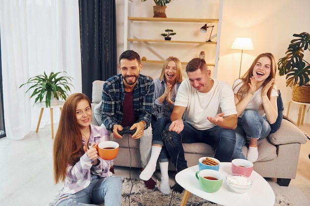 Photo spending weekend together group of friends have party indoors together