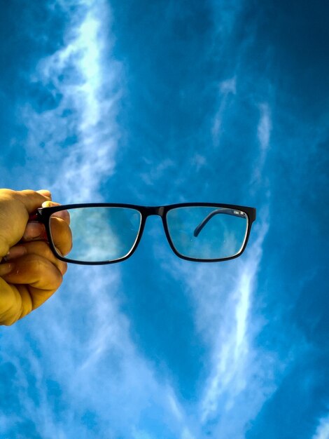 Spex in the hand and sky view