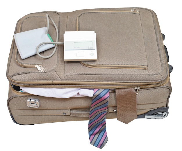 Photo sphygmomanometer on suitcase with male ties