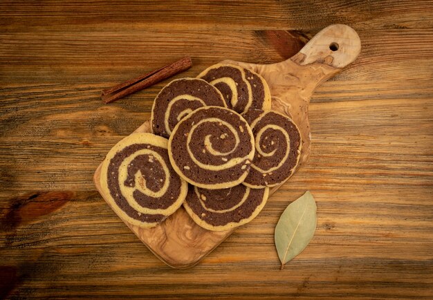 Spice cinnamon cookie with chocolate, coffee and nuts filling on wood background. Brown and white round soft biscuits, ginger molasses cookies, christmas gingersnap with copy space