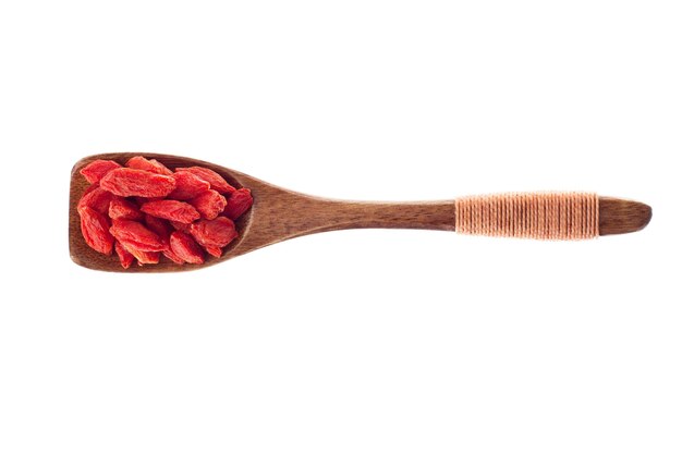 Spice Goji berry in  wooden spoon isolated on a white background, top view