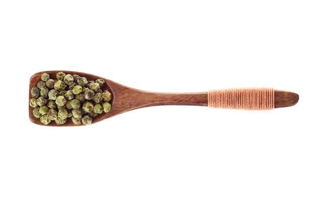 Spice Green peppercorn seeds in  wooden spoon isolated on a white background, top view