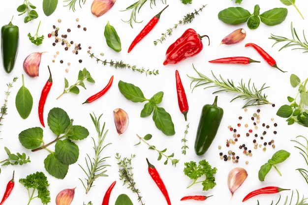 Photo spice herbal leaves and chili pepper on white background.