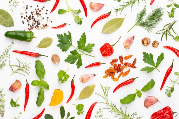 Spice herbal leaves and chili pepper on white. Vegetables pattern. Floral and vegetables on white. Top view, flat lay.