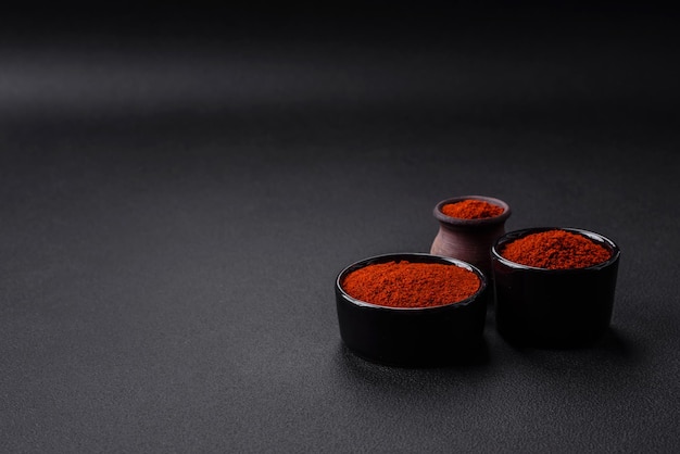 Spice smoked paprika in the form of powder in bowls and spoons