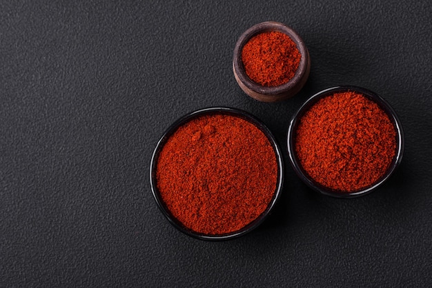 Spice smoked paprika in the form of powder in bowls and spoons