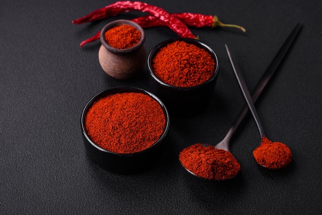 Spice smoked paprika in the form of powder in bowls and spoons
