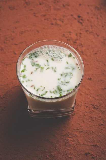 Photo spiced buttermilk also known as chaas,  taak or curd drink for indian summer, selective focus