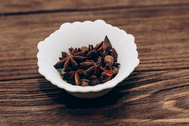 Spices anise pepper cumin cumin ginger in bowls on a wooden table