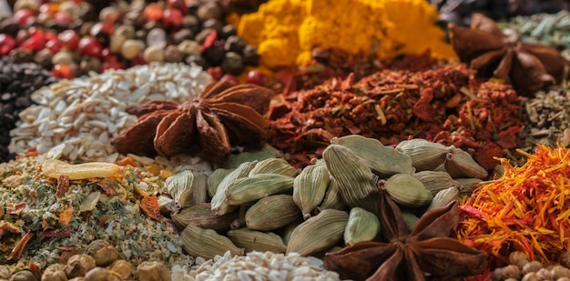 Spices aromatic indian spices on a slate background spices and\
herbs on stone