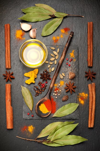 Spices on black stone board spicy top view