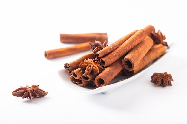 Spices concept Cinnamon sticks and star anise on white background with copy space