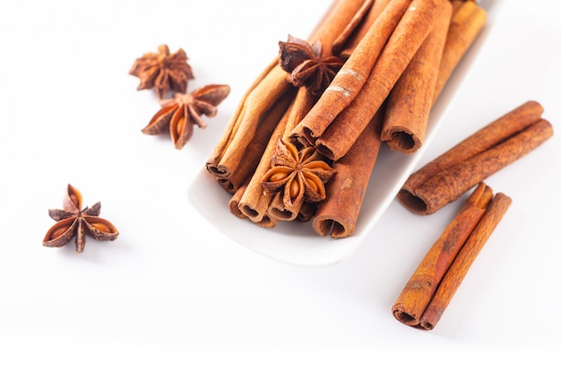 Spices concept Cinnamon sticks and star anise on white background with copy space