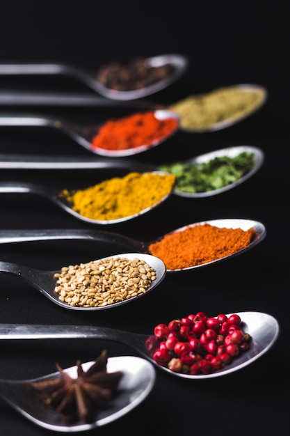 Spices and condiments for cooking on a black background