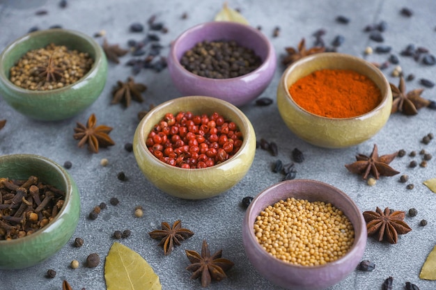 Spices in containers on a gray background